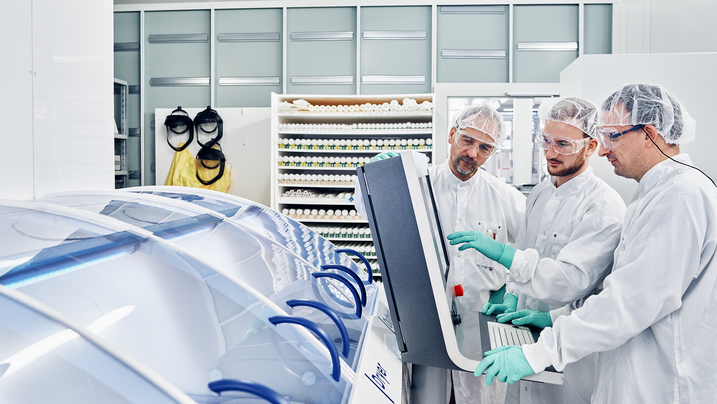 RENA employees working on a machine