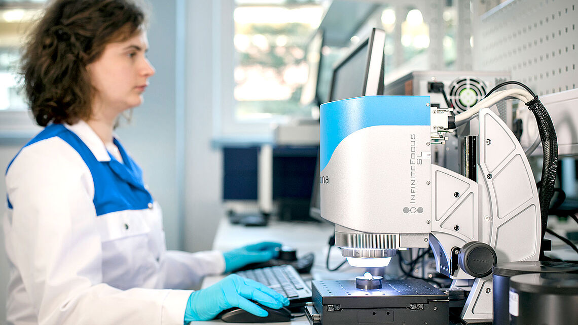  woman analyzes an object