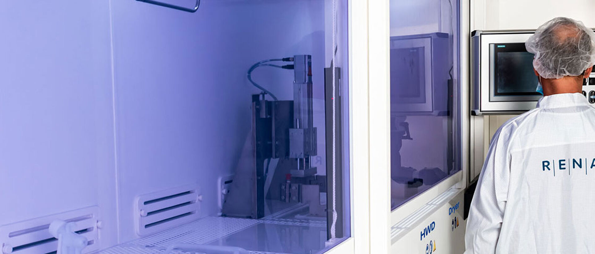 RENA employee working on a machine